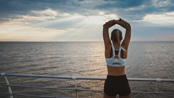 Sportive Disabled Woman Enjoying Sunset and Training on Pier Back View