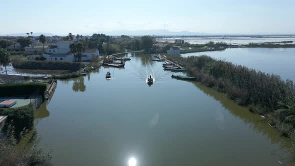 Aerial Drone Footage of Boats with Tourists on It to Visit the Natural Park of the Albufera in