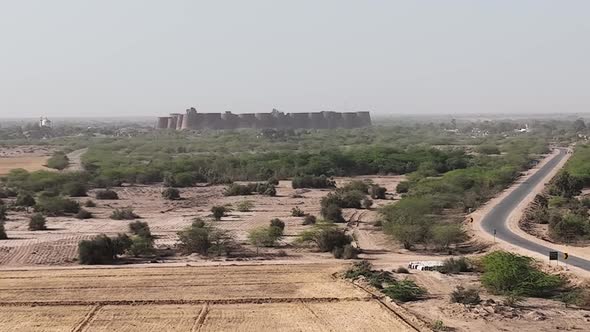 Aerial View Of Derawar Fort In the Distance Located In Ahmadpur East Tehsil, Punjab, Pakistan. Dolly