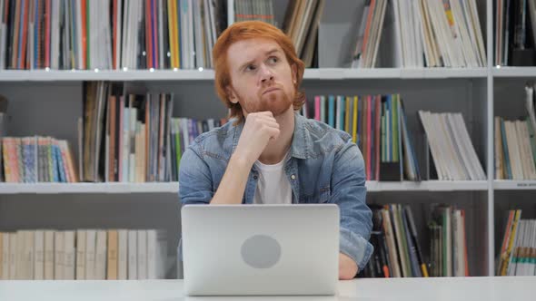 Pensive Man Thinking and Working on Laptop