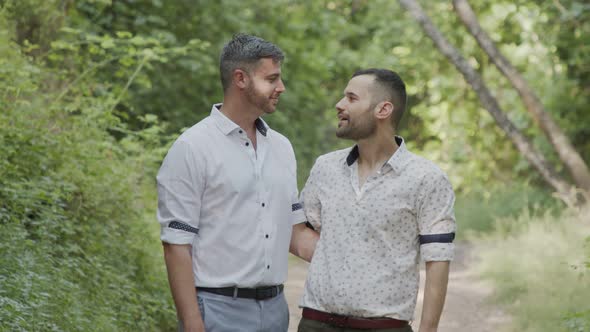 Gay couple during a photo shoot before their wedding in a forest