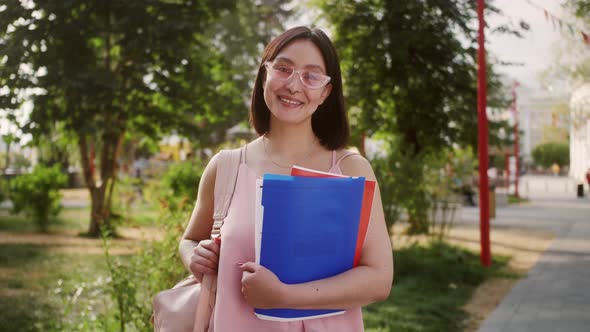 Student Asian Girl with Books Standing Near University Campus