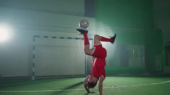 Professional Football Player Performs Tricks with a Soccer Ball Balances and Throws the Ball Slow