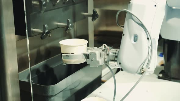 Robot with Artificial Intelligence Making Coffee on Coffee Machine