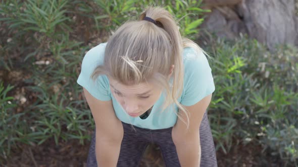 A young woman runner resting after jogging.