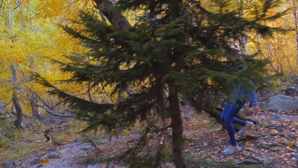 young tourist walks through mountainous area and looks at beautiful landscape.