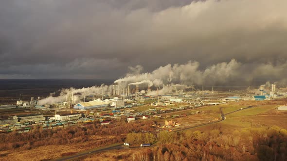 White Smoke Comes Out of a Large Number of Tall Chimneys of Chemical Plants Against the Backdrop of