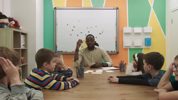 African American Teacher Teaches a Group of Children Mathematics in the Classroom