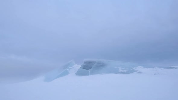 Snowstorm Carries Snowflakes through Transparent Ice.