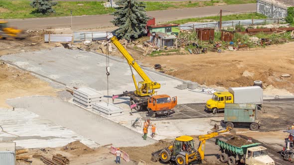 Aerial View of Large Road Construction Site with Several Industrial Machines Timelapse