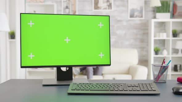 PC Screen with Isolated Mockup Green Screen Display in Bright Living Room