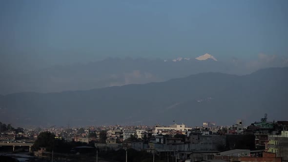 Stunning Views of the Snowy Peaks of the Himalayas Against a Blue Sky. Panorama of the City Lying in