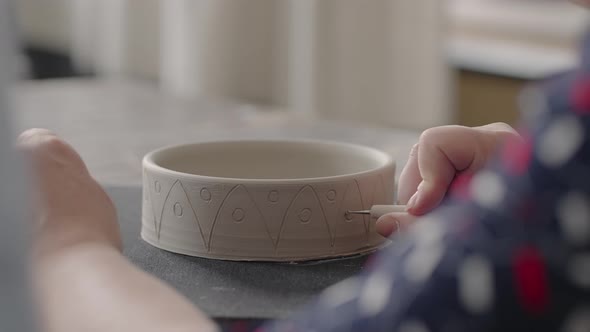 Woman Hands During Painting on Ceramic Plates