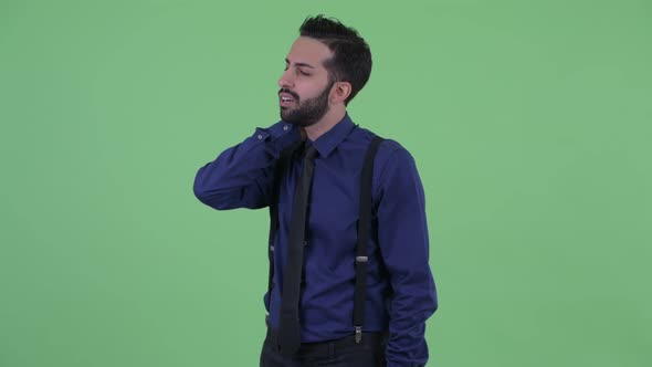 Stressed Young Bearded Persian Businessman Having Neck Pain