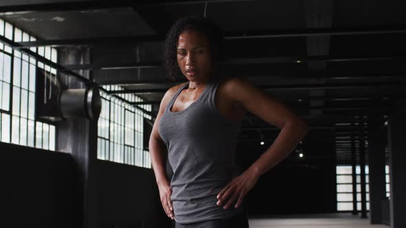 Portrait of african american woman taking a break breathing heavily and looking at the camera