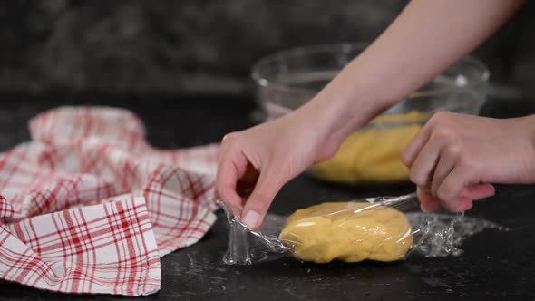 Wrapping The Dough In Clear Film Plastic Wrap.