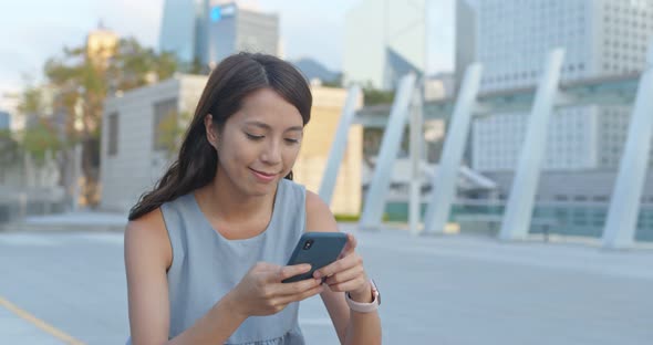 Woman use of mobile phone for online in city