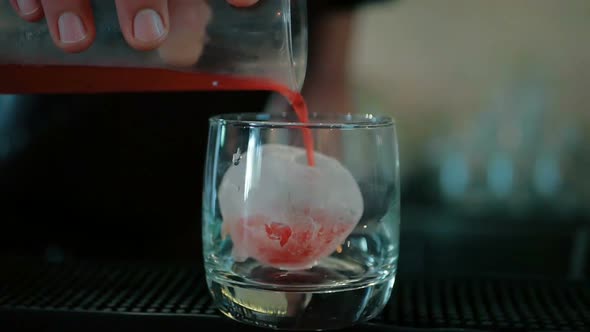 nightclub or pub, a professional bartender preparing a cocktail with ice a mix of alcohol. The barma