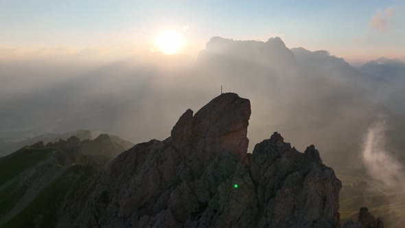 Sunrise in the Dolomites mountains with fog and mist