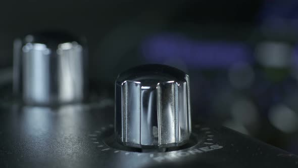 Female Fingers Turning Silver Audio Interface Knob