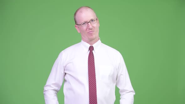 Mature Bald Businessman Showing Three Wise Monkeys Concept