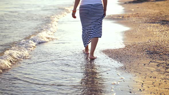 Woman Walking on the Seashore