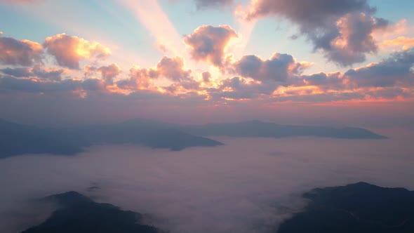 Flying over the clouds during morning sunrise