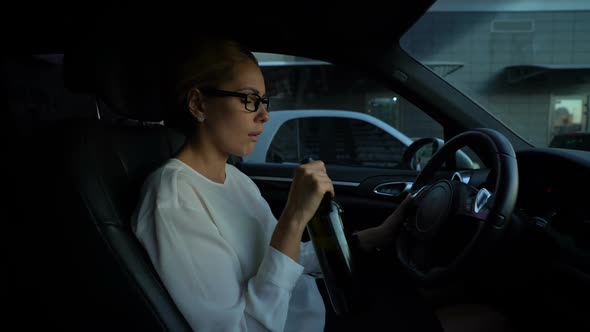 Depressed Woman Drinking Wine While Driving Car, Risk of Accident Dangerous Trip