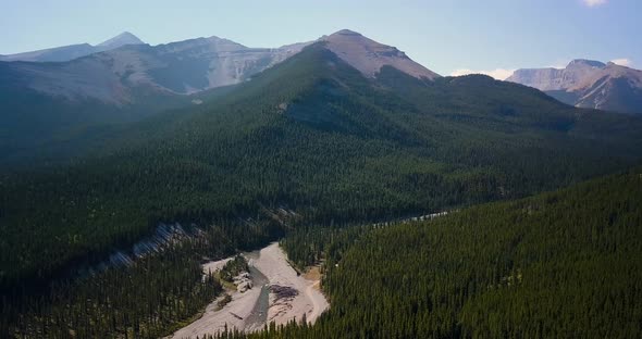 Aerial Daytime Wide Shot Moving Right Fast And Turning Left To Reveal A Swift Steep River Flowing Th