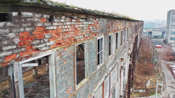 Aerial view of an old factory ruin and broken windows. Old industrial building for demolition.