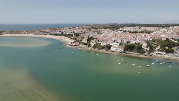 Aerial view of Vila Nova de Milfontes on bank of Rio Mira estuary, Portugal