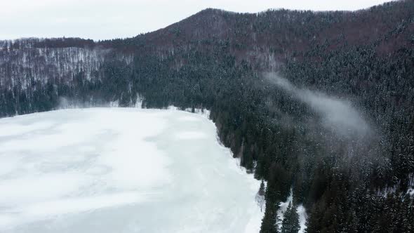 Frozen volcanic Saint Ann or Sfanta Ana lake crater, Romania. Aerial rising