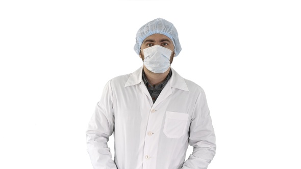 Portrait of medical doctor putting mask and hat on on white