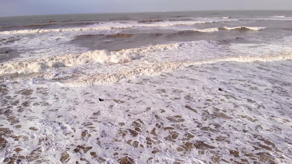 Aerial Flying Over Rough Sea Waves Along Katwijk aan Zee Beach Coastline In South Holland. Circle Do