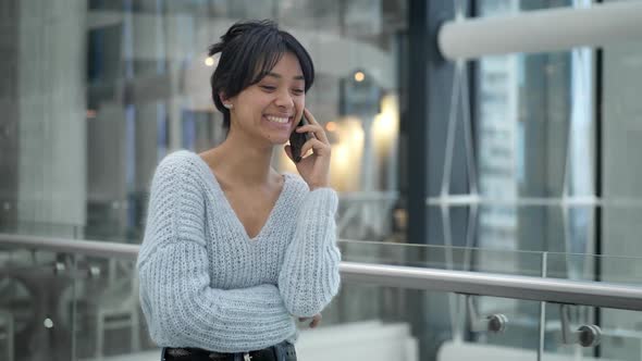 Middle Shot of Asian Female Laughing Talking on Phone While Walking