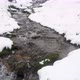 Winter stream flows between snowy shores - VideoHive Item for Sale