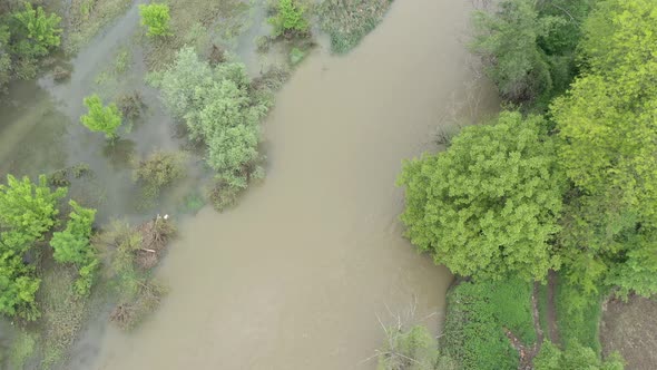 Flooded coastal area of narrow river 4K aerial footage