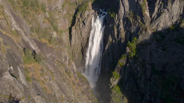 Beautiful cinematic drone shot of a waterfall in a mountain valley, Norway