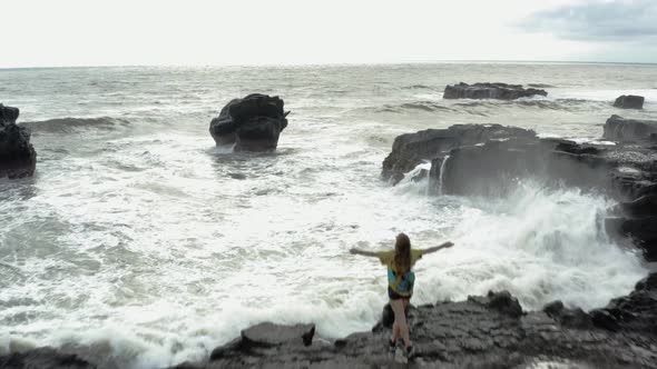 Female with Arms Wide Open Freedom Standing on Rock