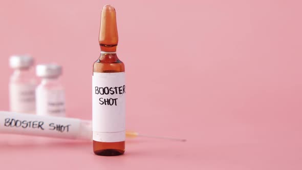 Booster Shot Dose Coronavirus Vaccine and Syringe on Blue