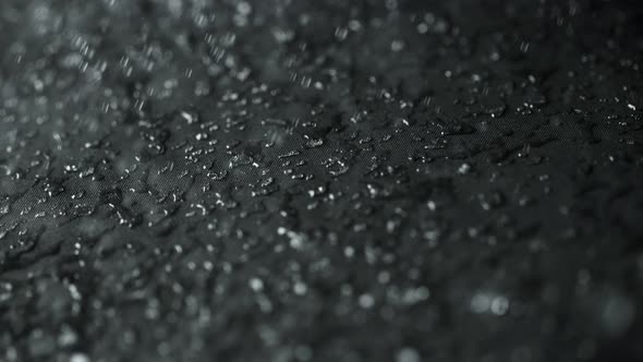 Super Slow Motion Shot of Water Droplets Splashing on Waterproof Cloth at 1000Fps