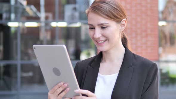 Outdoor Video Chat on Tablet by Young Businesswoman