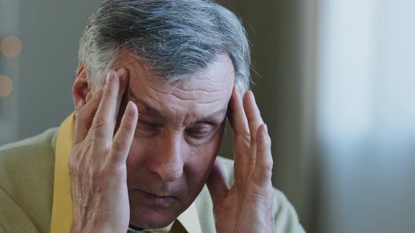 Closeup Exhausted Frustrated Face of Elderly Man Grandfather Massaging Nose Bridge Rub Temples