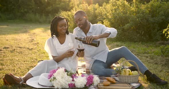 Black Loving Couple on a Summer Picnic on Meadow