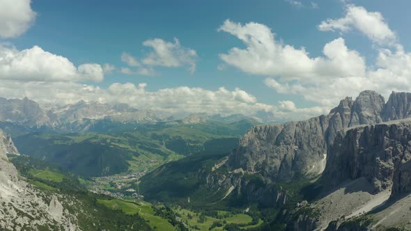 Aerial of green valley surrounded by dolomites mountains in south tyrol