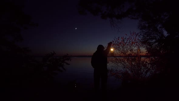 Girl with a Lamp on the River Bank