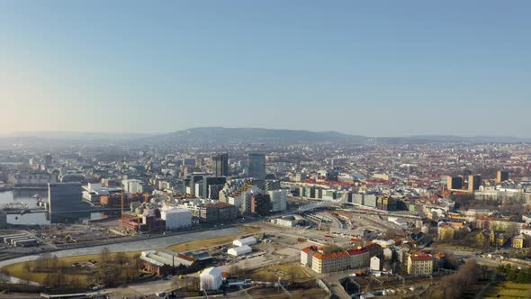 Overview of Oslo city centre and pan over the Oslofjord harbour with blue sky. Norway.4k drone stat