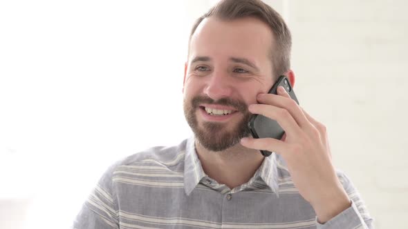 Happy Man Talking on Phone for Work