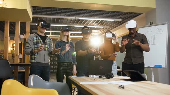 Hipster People Typing Something in VR Virtual Reality Glasses During Work Day