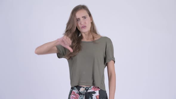 Young Angry Woman Looking Stressed While Giving Thumbs Down